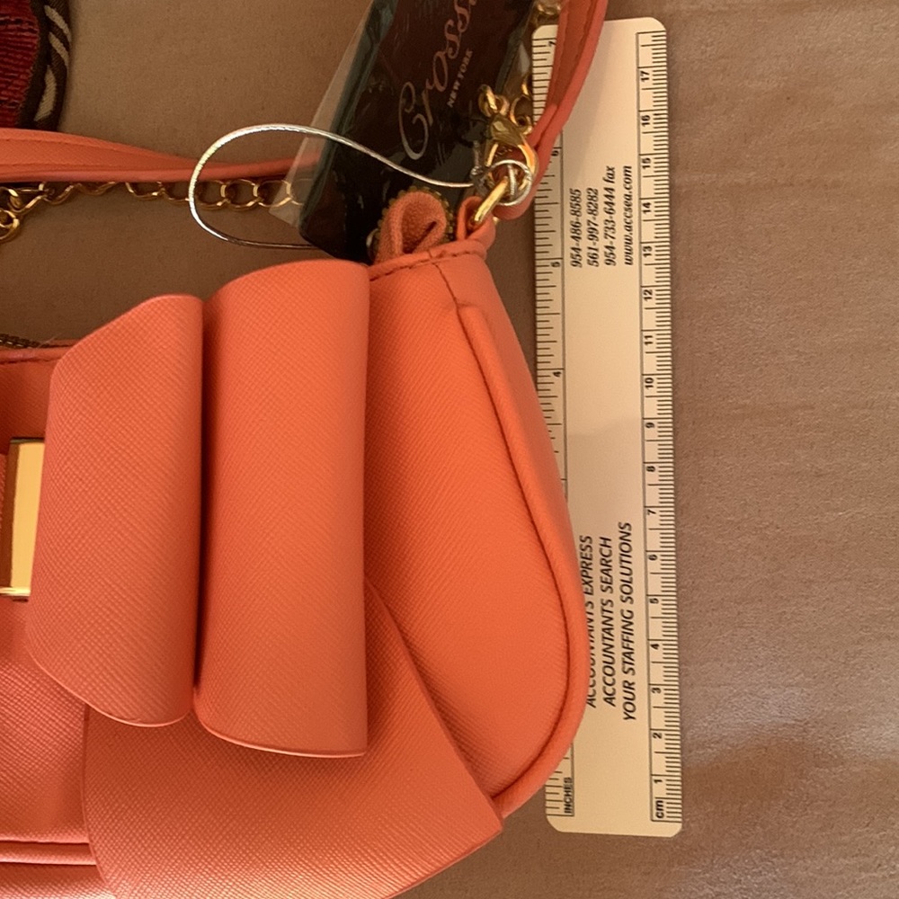 CROSSI NY. NWT. Beautiful Coral, crossbody bag with bow on front. Gold c… - Picture 5 of 8